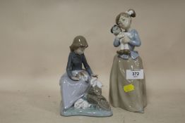 TWO NAO FIGURES OF A LADY WITH RABBITS AND A GIRL WITH A DOLL
