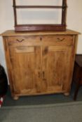 AN ANTIQUE PINE CUPBOARD WITH A SINGLE DRAWER ON BUN FEET H-116 W-109 D-51 CM
