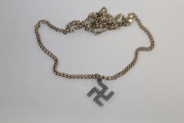 A SWASTIKA PENDANT ON STERLING SILVER CHAIN