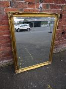 A LARGE MODERN GILT FRAMED MIRROR 115 X 90 CM