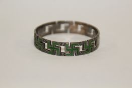 A HALLMARKED SILVER AND ENAMEL SWASTIKA NAPKIN RING