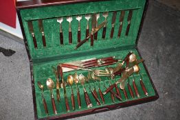 A LEATHER TOPPED CANTEEN OF WOODEN HANDLED CUTLERY