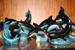A COLLECTION OF POOLE POTTERY DOLPHIN FIGURES AND A WHALE (6)