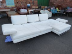 A LARGE DESIGNER WHITE LEATHER CORNER SUITE WITH ARM RESTS THAT RAISE AND LOWER