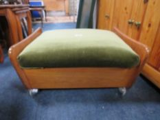 A RETRO TEAK STOOL ON CASTORS W-63 CM