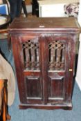 A COLONIAL STYLE CUPBOARD H-90 W-56 CM AND A CAST STOOL (2)