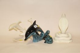 TWO POOLE FIGURES OF AN OTTER AND A DOLPHIN TOGETHER WITH TWO RESIN FIGURES OF A COBRA AND