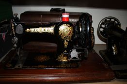 A MAHOGANY CASED JONES SEWING MACHINE TOGETHER WITH AN UNCASED SINGER EXAMPLE