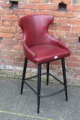 A MODERN RED LEATHER BAR STOOL