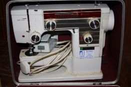 A CASED VINTAGE NEW HOME 609 ELECTRIC SEWING MACHINE
