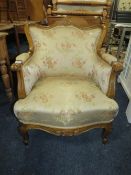 A LOUIS XV STYLE SILK UPHOLSTERED CARVED ARMCHAIR