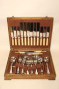 AN OAK CASED CANTEEN OF CHROME PLATED CUTLERY