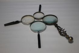 A GROUP OF FOUR VINTAGE MAGNIFYING GLASSES (4)