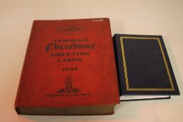 A SCRAP BOOK OF MATCH BOX COVERS, together with a smaller album containing transport related