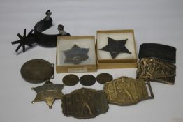 A SMALL COLLECTION OF COWBOY BELT BUCKLES AND REPRODUCTION SHERIFF BADGES together with a single
