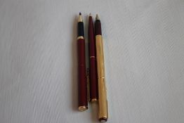 A PARKER 88 MAROON & GOLD FOUNTAIN PEN, gold plated (1988) together with two Parker Imperial Line (