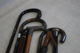 A COLLECTION OF WALKING STICKS, to include silver mounted examples