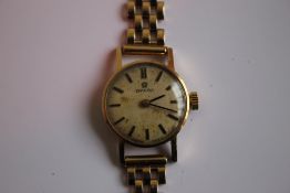 A LADIES OMEGA MANUAL WIND WRIST WATCH on an unbranded 9 ct gold strap, dedication inscription to