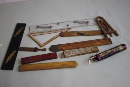 A COLLECTION OF VARIOUS WOODEN AND OTHER RULERS, to include folding types and a printed postal type