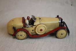 AN ORIGINAL 1930S MECCANO TIN PLATE RACING CAR, cream body with red trim, includes racing driver,