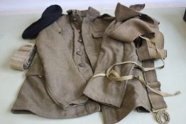 A BRITISH ARMY OTHER RANKS KHAKI TUNIC, with KSLI badges and general service buttons, along with cap