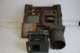 A TRAY OF PHOTOGRAPHIC EQUIPMENT to include magic lantern parts, plate holders etc.