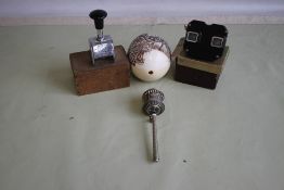 A WHITE METAL TIBETAN PRAYER WHEEL and a carved ostrich egg depicting wild animals, a bakelite