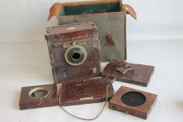 A WATSON AND SONS MAHOGANY TAILBOARD CAMERA, in fitted carry case with various related elements