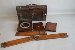 A 19TH CENTURY MAHOGANY PLATE CAMERA A/F IN LEATHER CASE WITH A TRIPOD