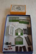 A BOXED BRITAIN'S MINIATURE GARDENING SPAN ROOF GREENHOUSE No. 053, pieces wrapped in newspaper