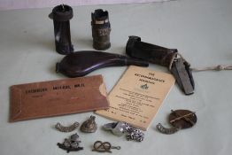 A SMALL QUANTITY OF MILITARY BADGES, two mortar fins, a trench art shell, Jack knife, shot flask