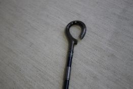 A SILVER HANDLED WALKING STICK CANE WITH LOOP STYLE HANDLE, with foliage decoration hallmarked