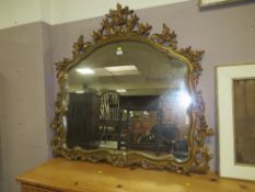 A CONTEMPORARY GILT PIERCED SHAPED WALL MIRROR H-116 W-122 CM