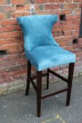 A MODERN UPHOLSTERED BAR STOOL