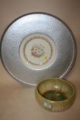 A RUSKIN POTTERY STYLE BOWL TOGETHER WITH A FLORAL LIMOGES PLATE IN METAL SURROUND, OVERALL DIAMETER