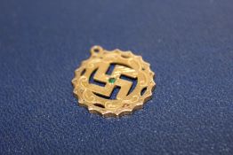 A YELLOW METAL SWASTIKA PENDANT STAMPED 22C