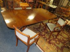 A 'BRIGHTS OF NETTLEBED' EXTENDING MAHOGANY TWIN PEDESTAL DINING TABLE AND FOUR CHAIRS - ONE SPARE