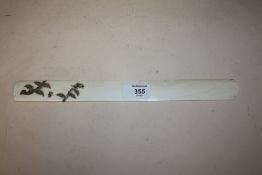 A JAPANESE MEIJI PERIOD IVORY PAGE TURNER WITH SILVER SCROLLING DETAIL, the silver formed as a