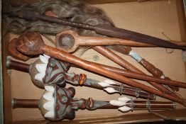 TWO INDONESIAN BORNEO BLOW PIPES, TOGETHER WITH FOUR LARGE CARVED WOODEN LADLES AND SPOONS, FLY