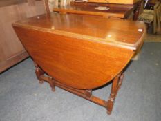AN EARLY 20TH CENTURY VINTAGE OAK DROPLEAF TABLE