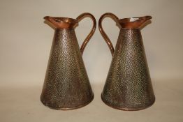 A PAIR OF ARTS AND CRAFTS STYLE HAMMERED FINISH COPPER JUGS, H 37 CM