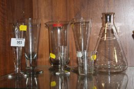A COLLECTION OF VINTAGE GLASS MEASURES TOGETHER WITH A CONICAL FLASK (7)
