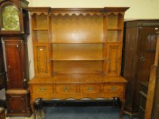 A QUALITY BURR WALNUT DRESSER WITH FOUR DRAWERS, RAISED ON CABRIOLE SUPPORTS WITH FLUTED DETAIL H-
