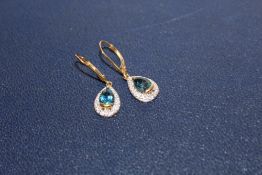 A PAIR OF LADIES 9 CT GOLD EARRINGS SET WITH BLUE TOPAZ STONES