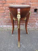 A CONTINENTAL WALNUT JARDINAIRE STAND WITH CIRCULAR MARBLE COVER AND GILT METAL FIGURATIVE MOUNTS