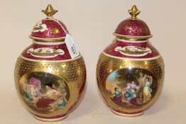 A PAIR OF ROYAL VIENNA GILDED PORCELAIN LIDDED VASES, each with blue beehive mark and titled in
