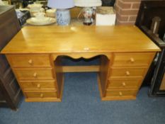 A MODERN PINE EFFECT TWIN PEDESTAL DESK W- CM