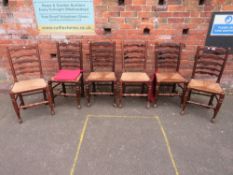 A SET OF SIX OAK LADDERBACK WICKERSEAT CHAIRS