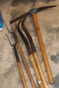 A SMALL SELECTION OF VINTAGE TOOLS TO INCLUDE A PICKAXE, HAY FORKS ETC PLUS A STRIMMER