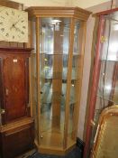 A MODERN OAK VENEER CORNER DISPLAY CABINET